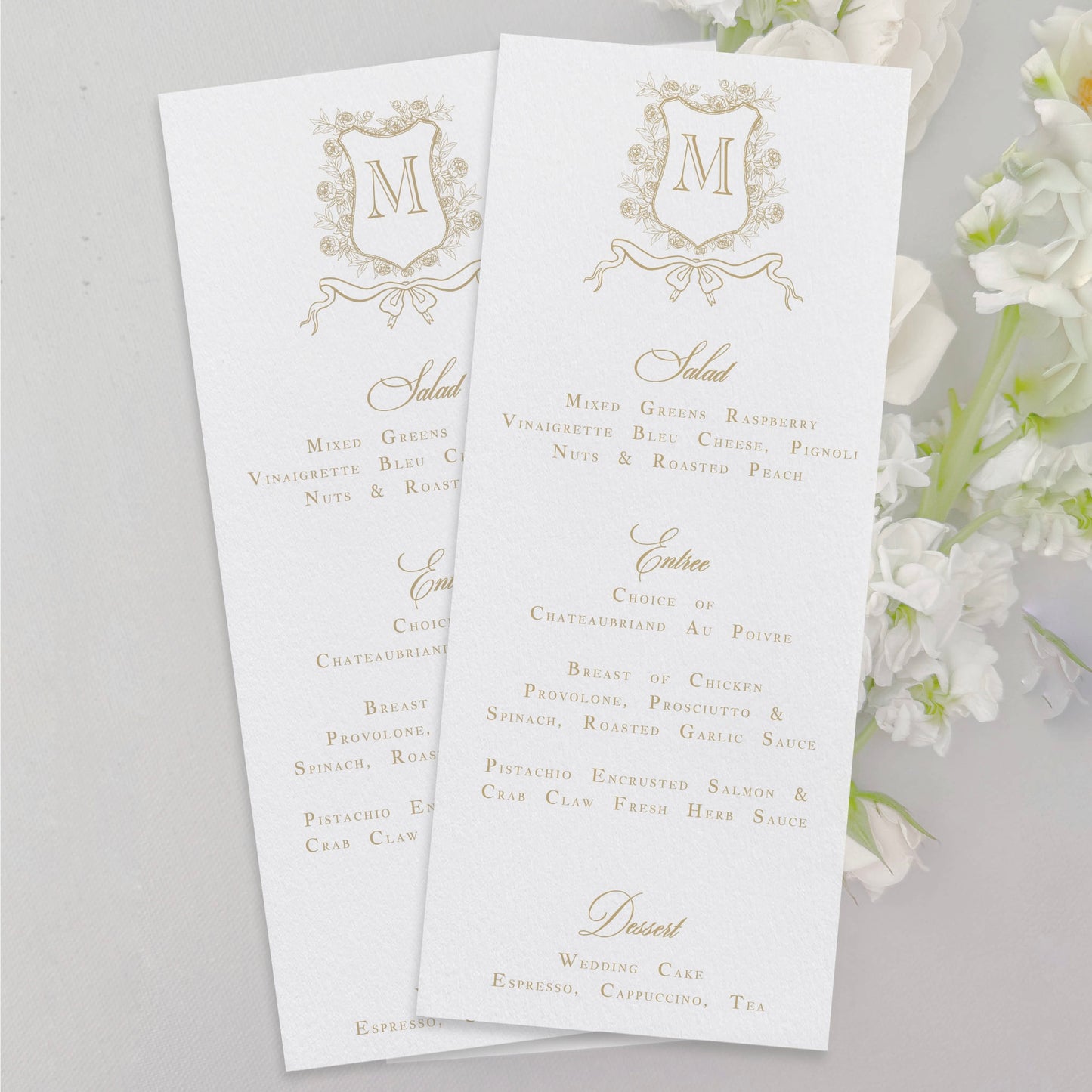 Elegant wedding menu cards shown with monogram crest details, script & text font, and gold flat matte ink.