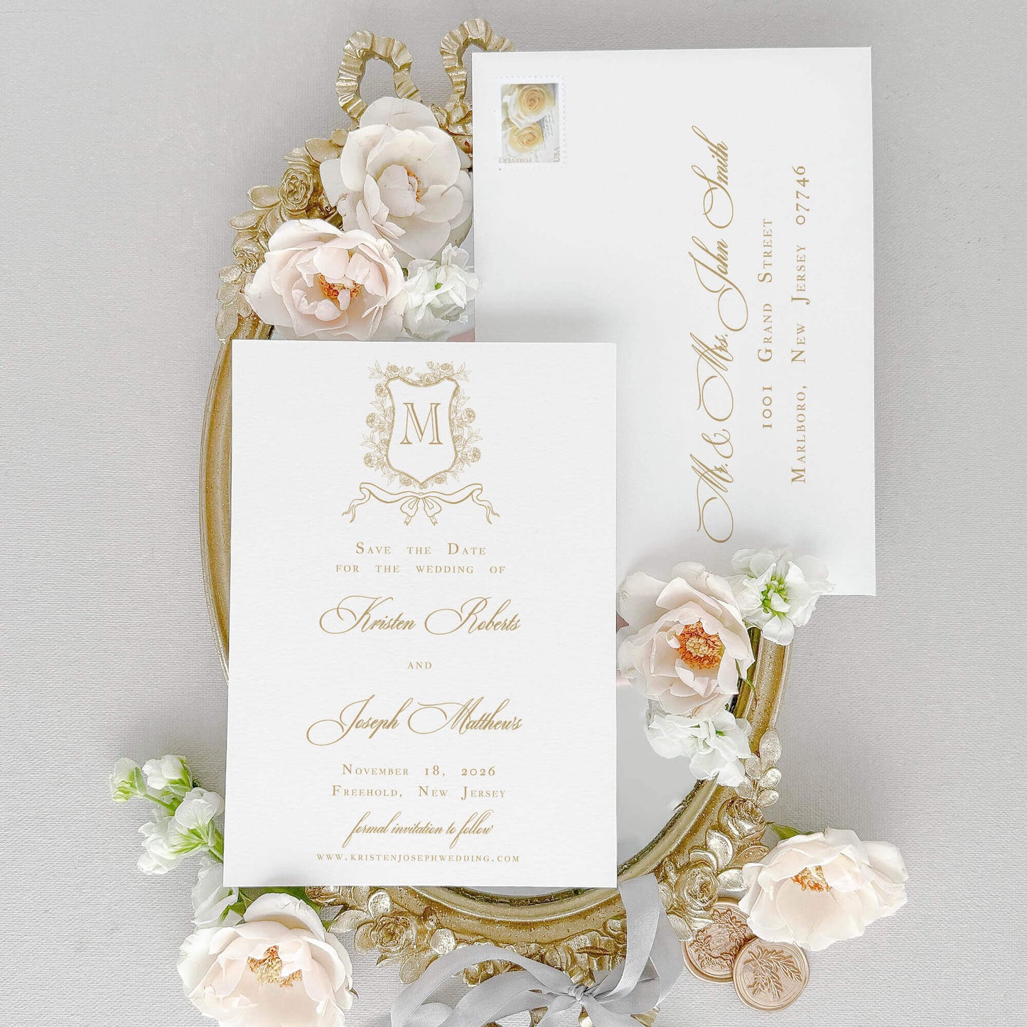 Classic Save the Date Card for Wedding shown with an elegant floral monogram crest artwork, gold ink, classic script and text fonts.