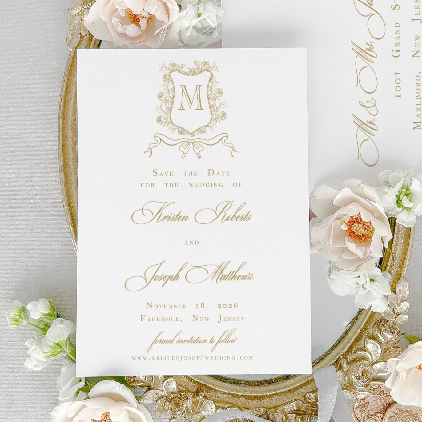 Classic Save the Date Card for Wedding shown with an elegant floral monogram crest artwork, gold ink, classic script and text fonts.